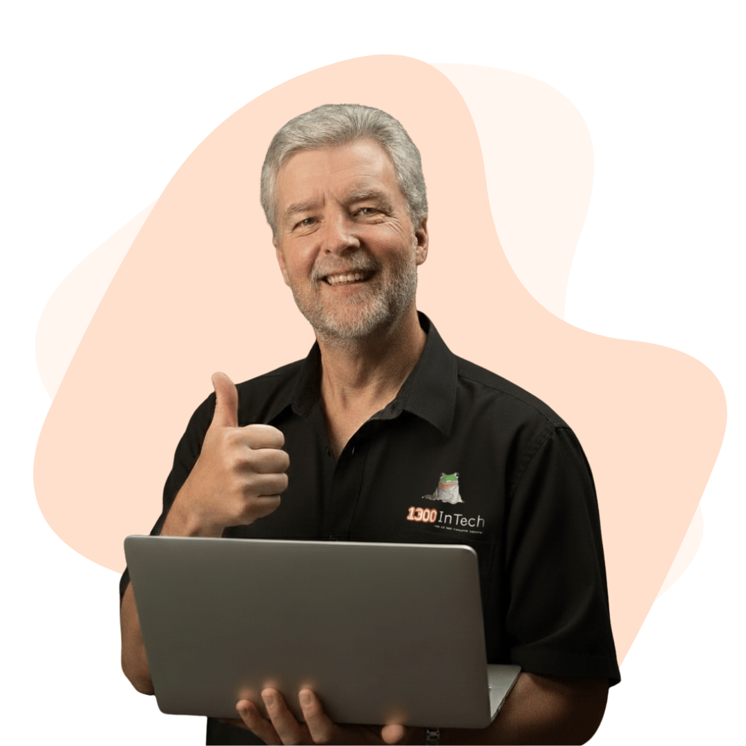Smiling 1300 INTECH Managing Director with a laptop, representing reliable managed IT services in Melbourne