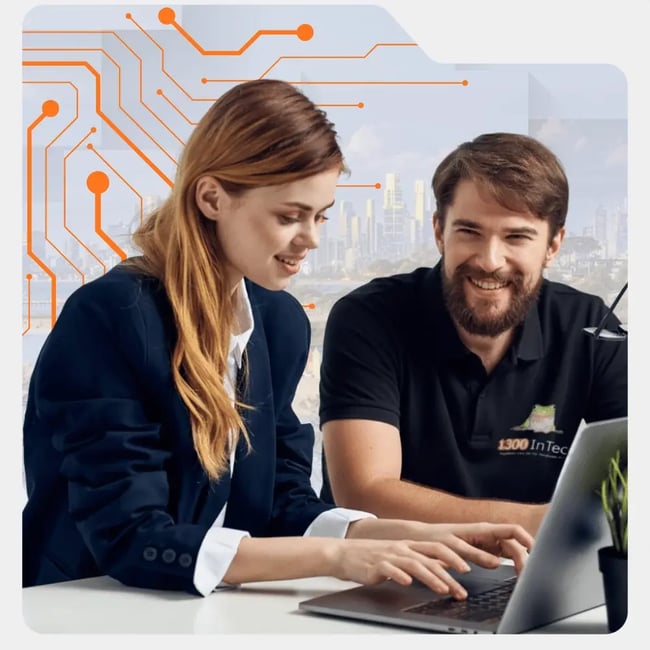 1300 InTech technician working with a client to provide tailored IT solutions in Melbourne for business needs