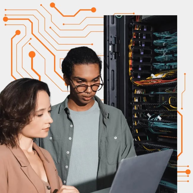 Two office professionals smiling while reviewing laptop solutions with a Melbourne IT services tech support