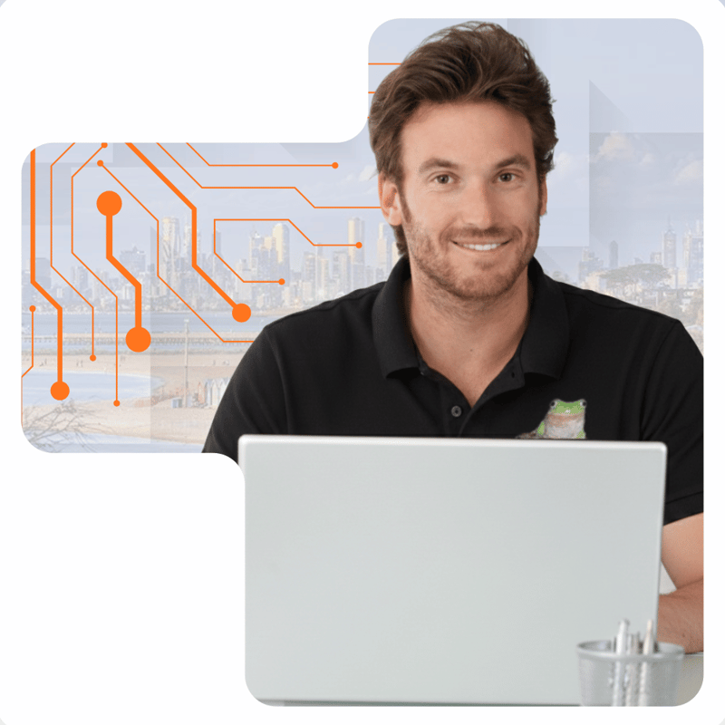 1300 INTECH technology support specialist in Blackburn working on a laptop in a modern business setting