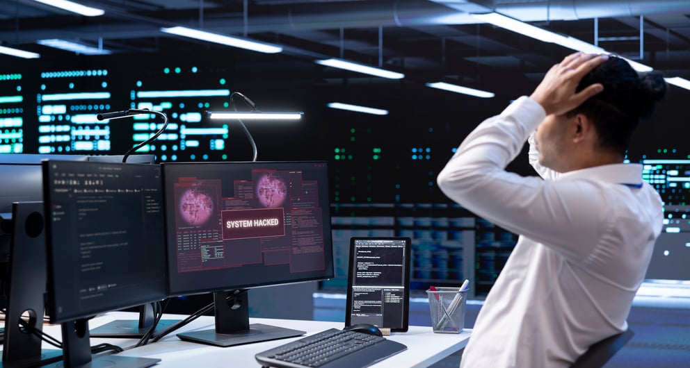 https://21106058.fs1.hubspotusercontent-na1.net/hubfs/21106058/close-up-data-center-employee-stressed-by-security-breach-alert.jpg