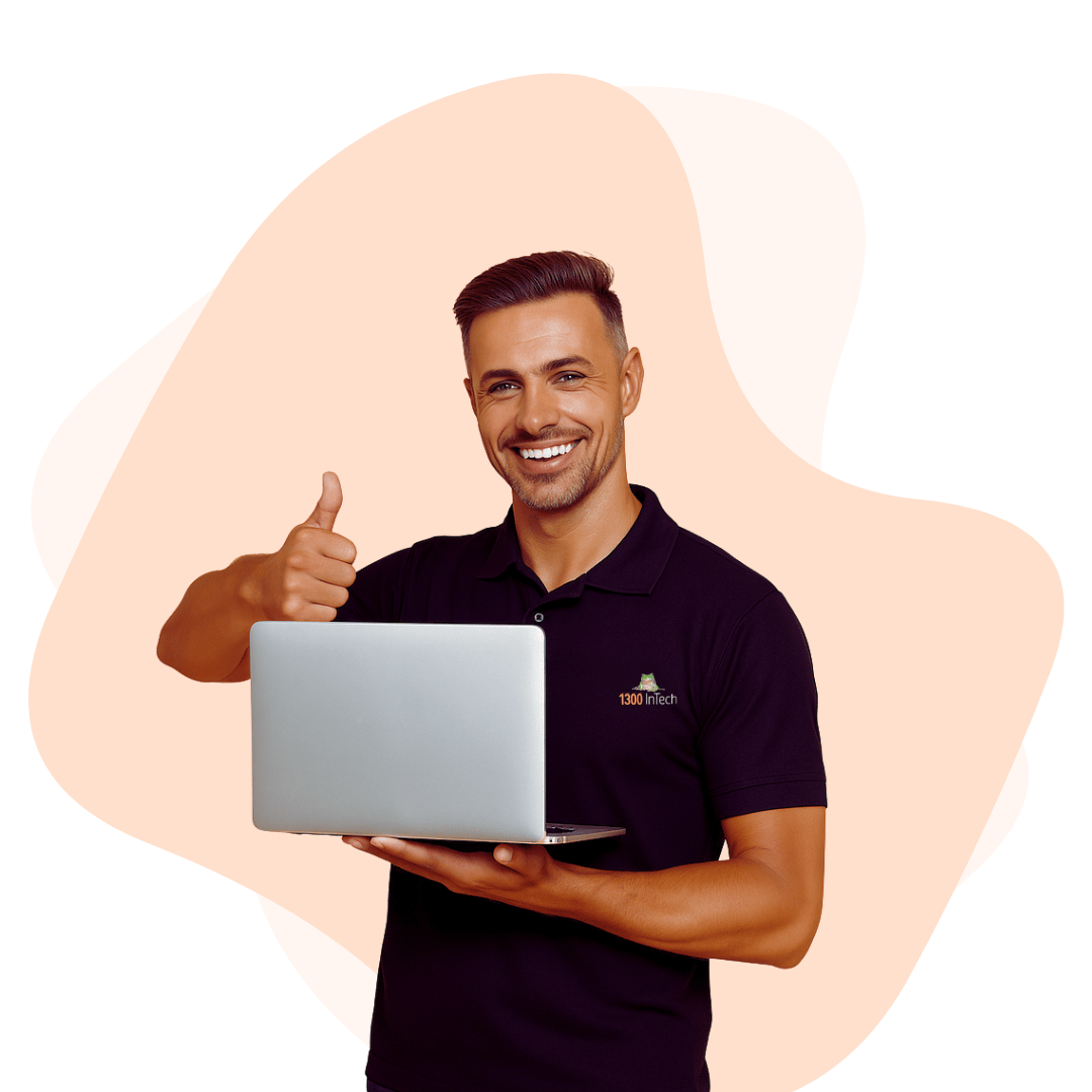 Smiling tech professional with laptop, representing 1300 INTECH's business IT support services