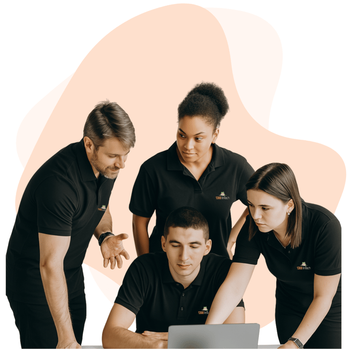  IT team collaborating on a laptop to deliver managed services and customized support solutions for business continuity