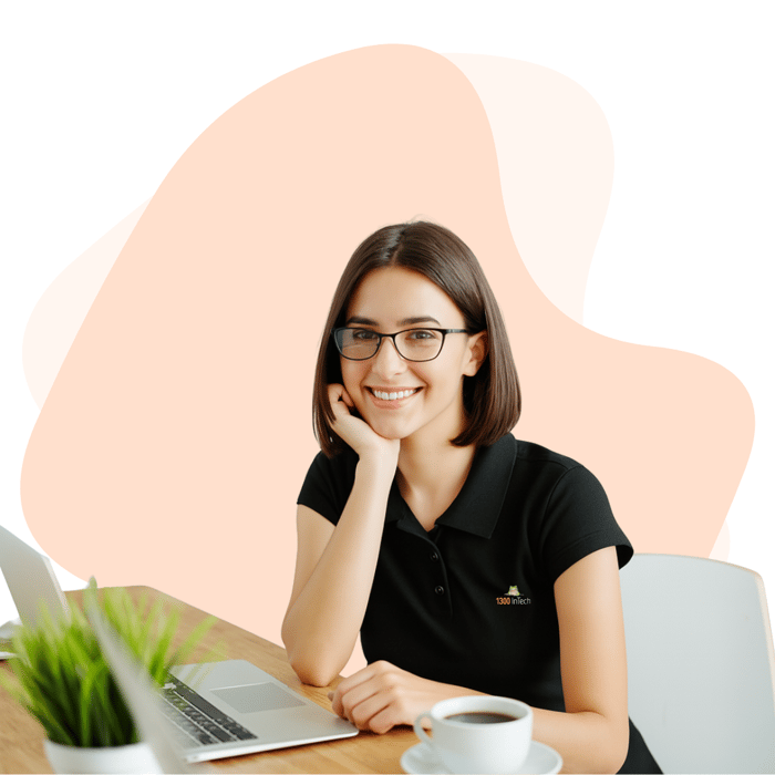 Woman smiling confidently while working remotely on her laptop, demonstrating productivity and focus in a modern workspace