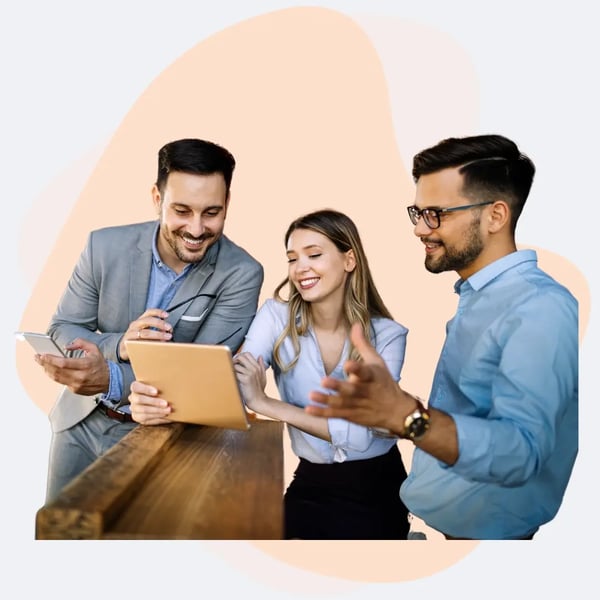 IT professionals collaborating on managed IT services strategy using a tablet and smartphone in a modern business setting