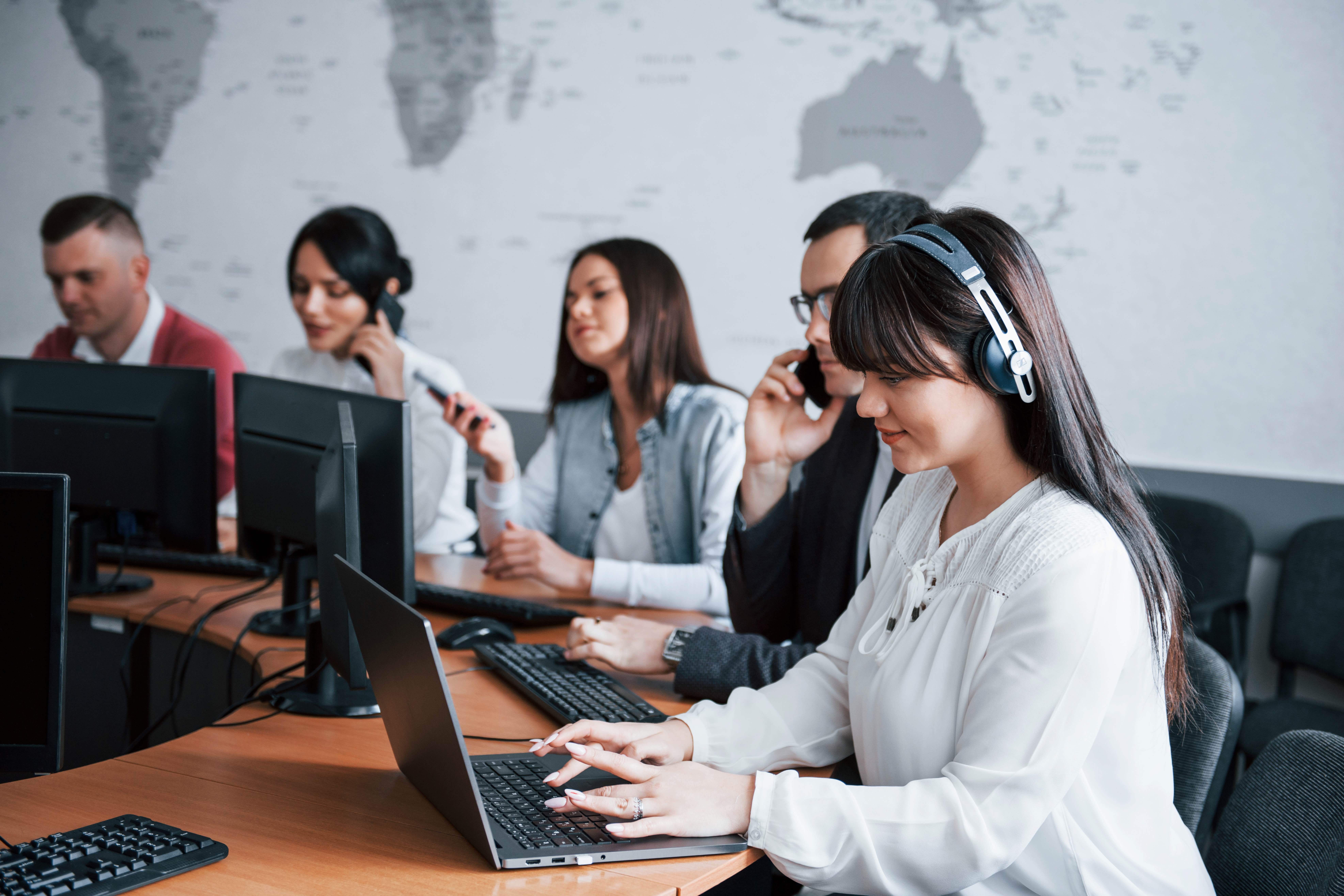 A Blackburn business support team providing remote assistance using laptops, phones, and headsets