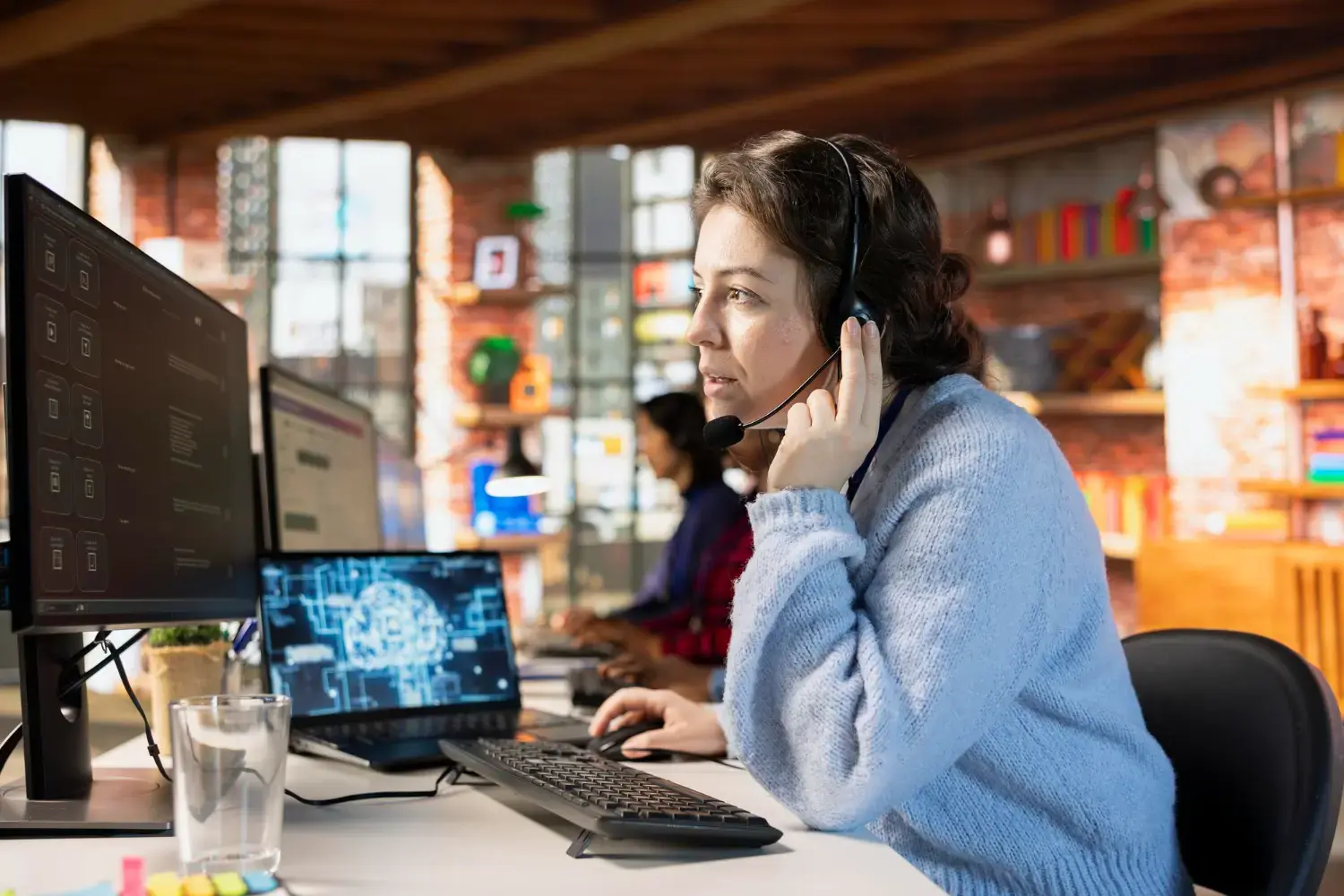 IT Help Desk personnel assisting with a client query.
