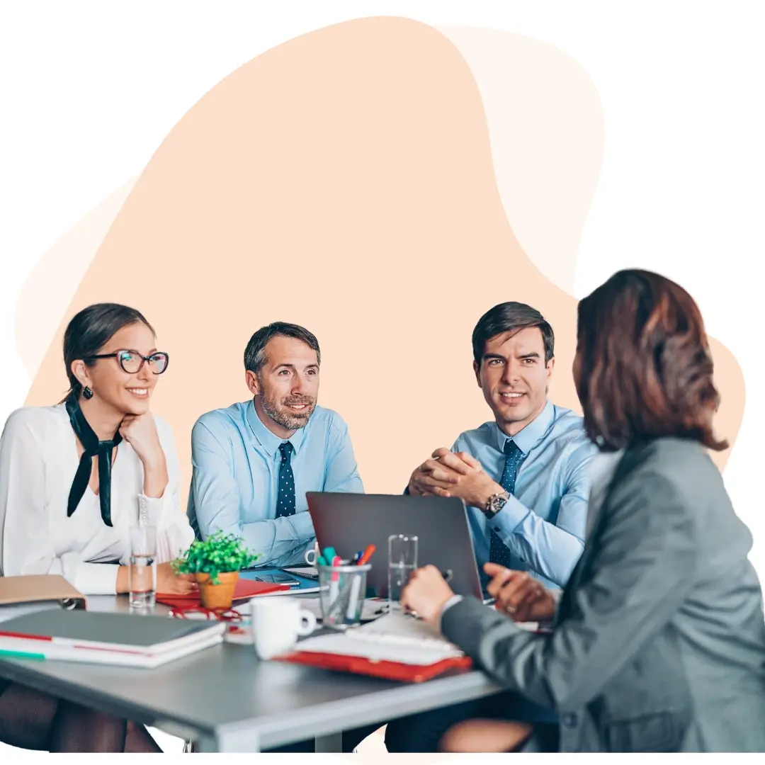 IT service team reviewing project plans and tech support strategies around a conference table IT service team reviewing project plans and tech support strategies around a conference table